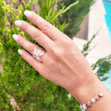 Load image into Gallery viewer, Model is wearing a butterfly adjustable ring on ring finger.  Bushes are in the background.