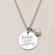 Load image into Gallery viewer, Picture of Kindness Changes Everything Inspirational Necklace on a tan background