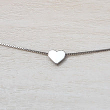 Load image into Gallery viewer, Elegant Heart Sterling Silver Necklace on a tan background.