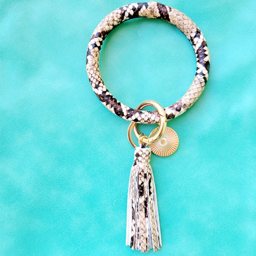 Snakeskin Print Key Ring Bracelet on a blue background. 