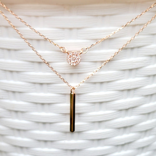 Rose Gold Disc and Bar Necklace with white background. 