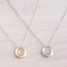 Load image into Gallery viewer, Silver and Gold Geometric Charm Necklaces on a tan surface.