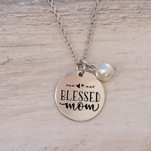 Load image into Gallery viewer, Picture of Blessed Mom Disc and Charm Necklace with white charm on a grey background.