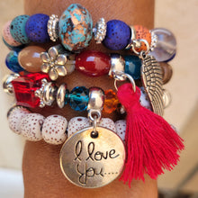 Load image into Gallery viewer, Black Tasseled Beaded Layering Bracelet with all four bracelets laid out separately on a model's wrist