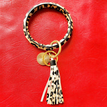 Load image into Gallery viewer, Leopard Print Key Ring Bracelet on red background.