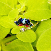 Load image into Gallery viewer, Picture of Flower Two-toned Adjustable Sterling Silver Ring laying in green leaves