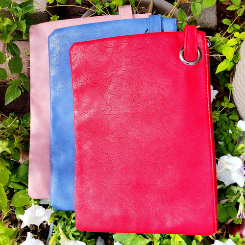 Versatile Oversized Clutch from left to right- pink, blue, red on leaves and white flowers. 