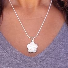 Load image into Gallery viewer, Picture of Flower Sterling Silver Necklace on a model with a grey shirt and brown curly hair