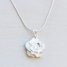 Load image into Gallery viewer, Picture of Flower Sterling Silver Necklace on a tan background