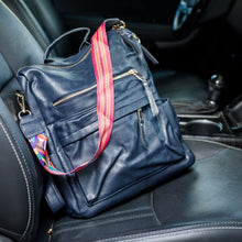 Load image into Gallery viewer, Navy convertible bag in a car with black seats