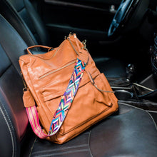 Load image into Gallery viewer, Brown convertible bag in a car with black seats