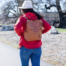 Load image into Gallery viewer, Model in white hat, red shirt, and jeans wearing a tan convertible bag