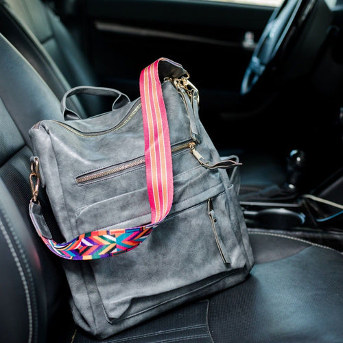 Grey convertible bag in a car with black seats