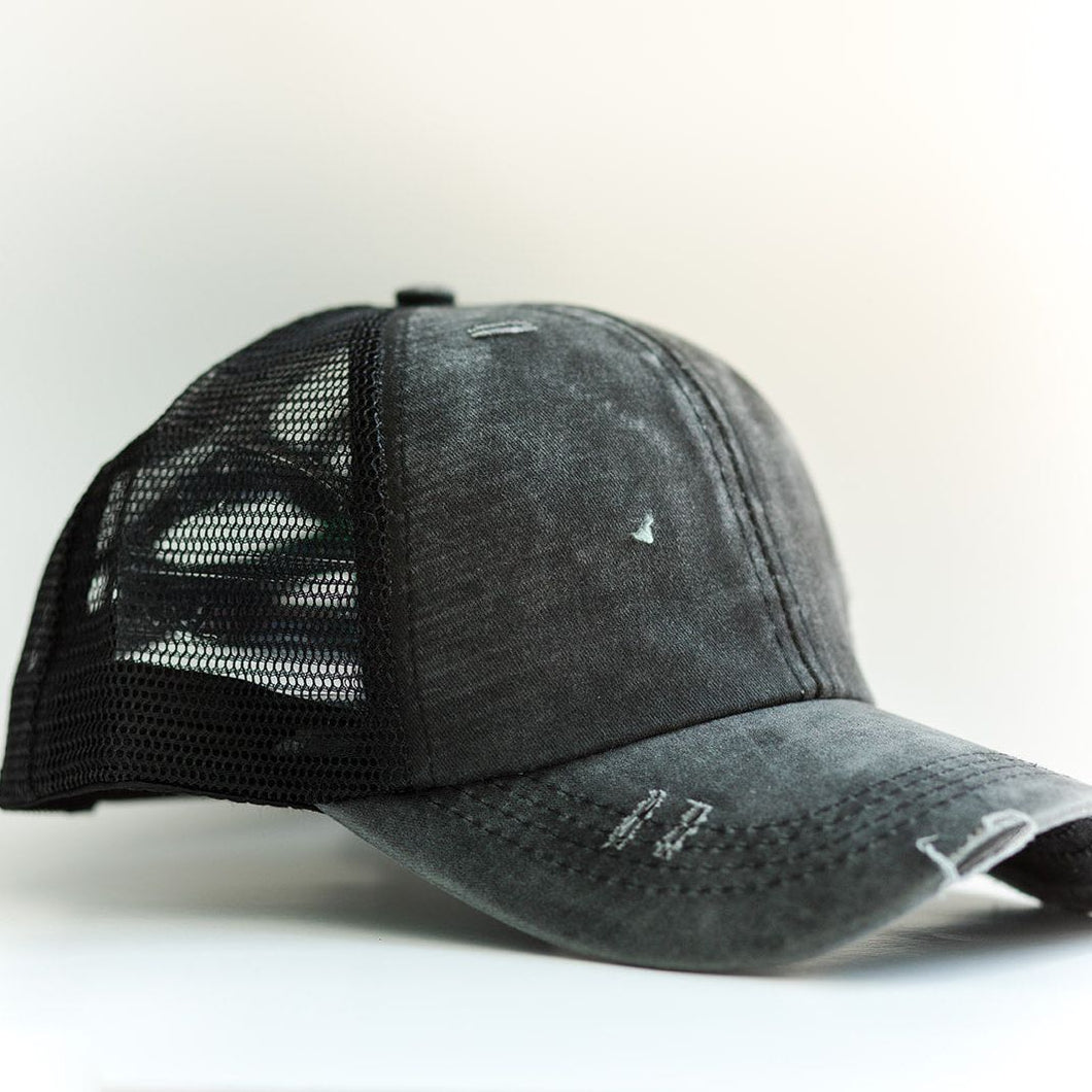 Black Distressed Ponytail & Messy Bun Baseball Cap side view with a white background