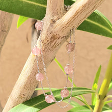 Load image into Gallery viewer, Picture of Double Strand Strawberry Crystal Sterling Silver Bracelet hanging on a tree branch with a tan wall and leaves in the background
