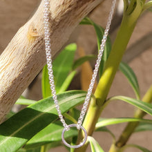 Load image into Gallery viewer, Double Strand Circle Sterling Silver Bracelet hanging on a branch with green leaves in the background. 
