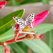 Load image into Gallery viewer, Picture of butterfly zircon adjustable sterling silver ring on pink flower bud with green leaves in the background. 
