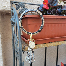 Load image into Gallery viewer, Snakeskin Print Key Ring Bracelet hanging on a brown planter
