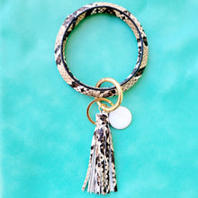 Load image into Gallery viewer, Snakeskin Print Key Ring Bracelet on a blue background.
