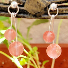 Load image into Gallery viewer, Strawberry Crystal Sterling Silver Dangle Earring on tan metal with leaves and red in the background. 
