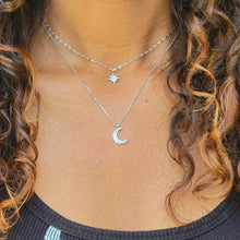 Load image into Gallery viewer, Star and Crescent Moon Double Strand Necklace on a model with long brown hair and a black shirt.
