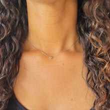 Load image into Gallery viewer, Elegant Heart Sterling Silver Necklace on a model&#39;s neck. Model has long brown curly hair and a black shirt.
