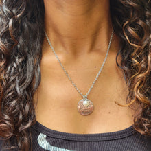 Load image into Gallery viewer, Picture of Be the Change You Wish to See in the World Inspirational Necklace with white charm on a model with brown curly hair and a black shirt. 
