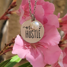 Load image into Gallery viewer, Mom Hustle Disc and Charm Necklace with pink flowers in the background  
