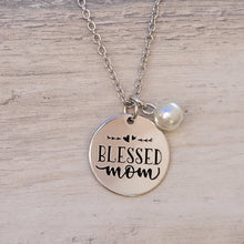Load image into Gallery viewer, Picture of Blessed Mom Disc and Charm Necklace with white charm on a grey background.
