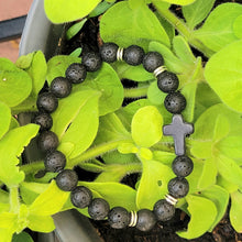 Load image into Gallery viewer, Silver Accent Beaded Cross Bracelet Black on a leaves.
