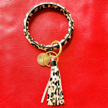 Load image into Gallery viewer, Leopard Print Key Ring Bracelet on red background.
