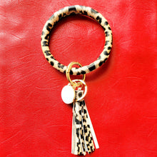 Load image into Gallery viewer, Leopard Print Key Ring Bracelet on red background. 
