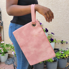 Load image into Gallery viewer, Versatile Oversized Clutch pink on model with black shirt and jeans
