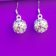 Load image into Gallery viewer, Picture of Hollow Ball Heart Earrings with a purple background 
