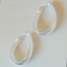 Load image into Gallery viewer, Textured Sterling Silver Hoop Earrings on a tan background. 
